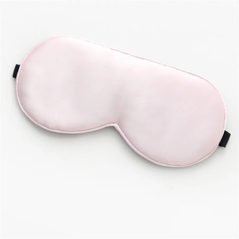 light pink, silk sleeping mask on a white background